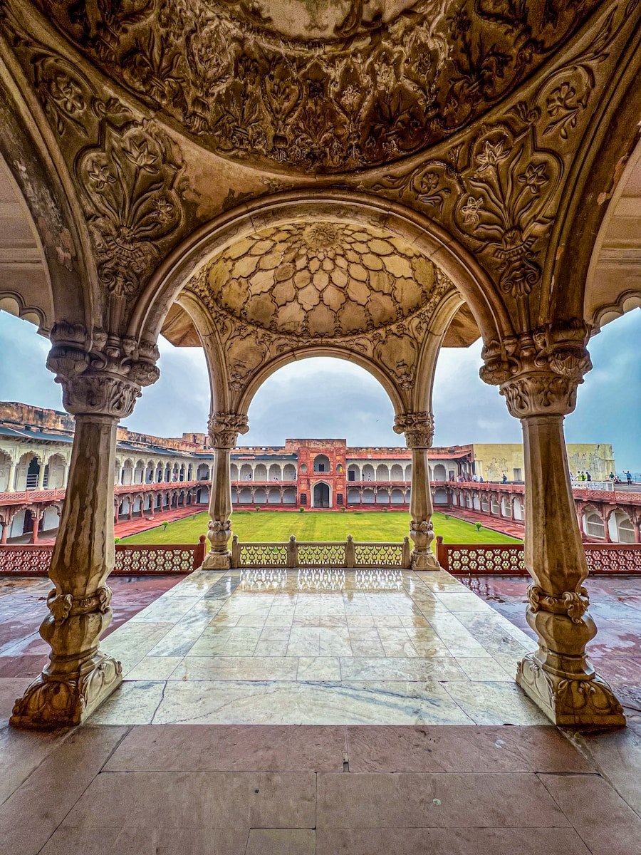 a large ornate archway with a building in the background