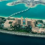 aerial photography of concrete buildings on the middle of the sea