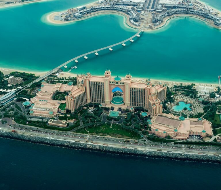 aerial photography of concrete buildings on the middle of the sea