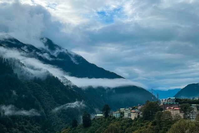 a scenic view of a town nestled in the mountains